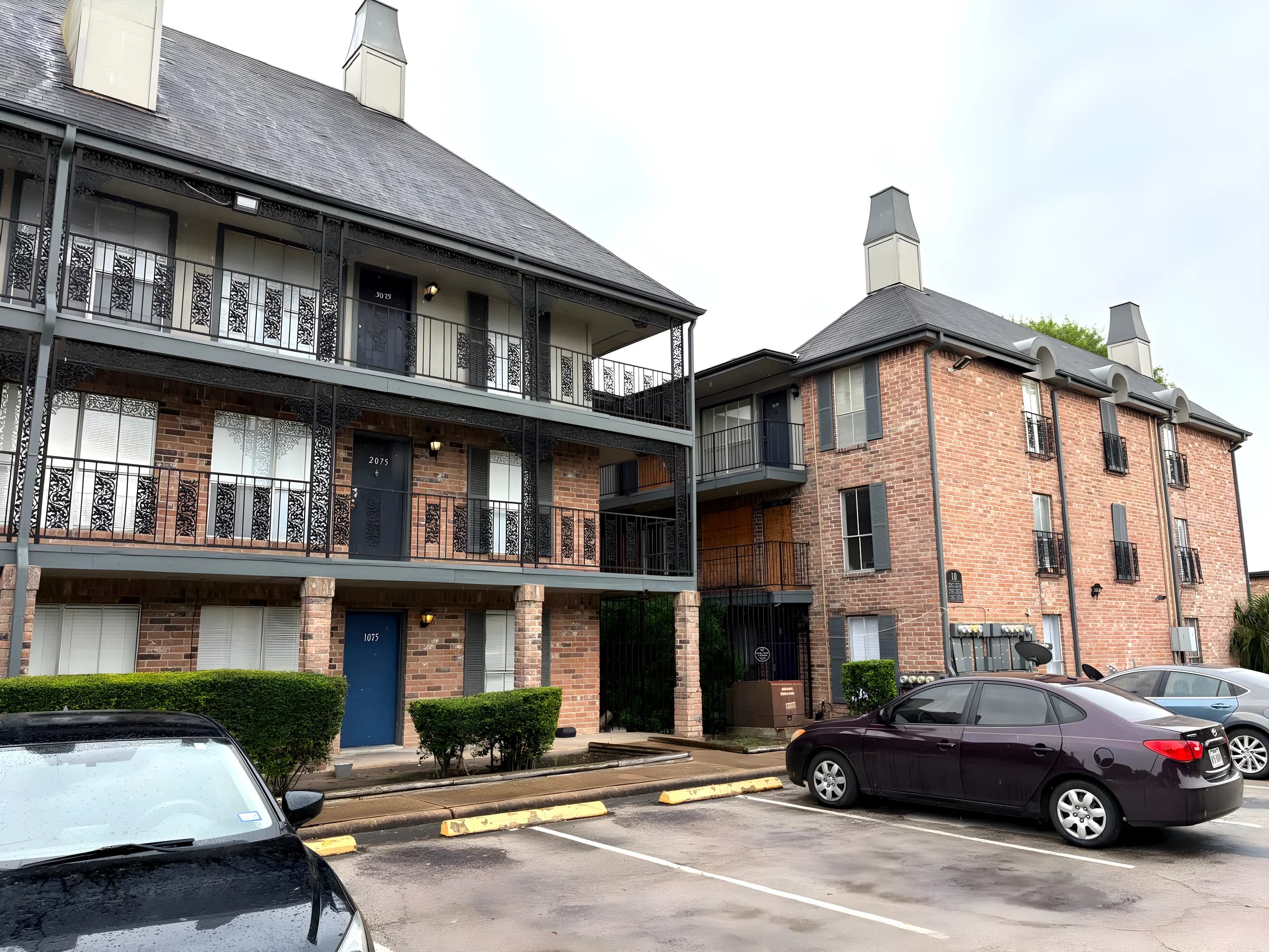 Brick buildings with mansard roofs and iron railings